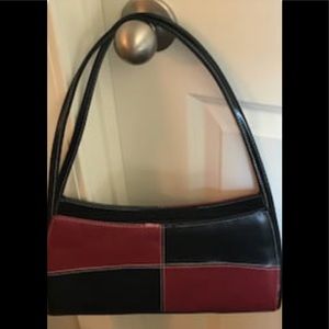 Unmarked leather look handbag.